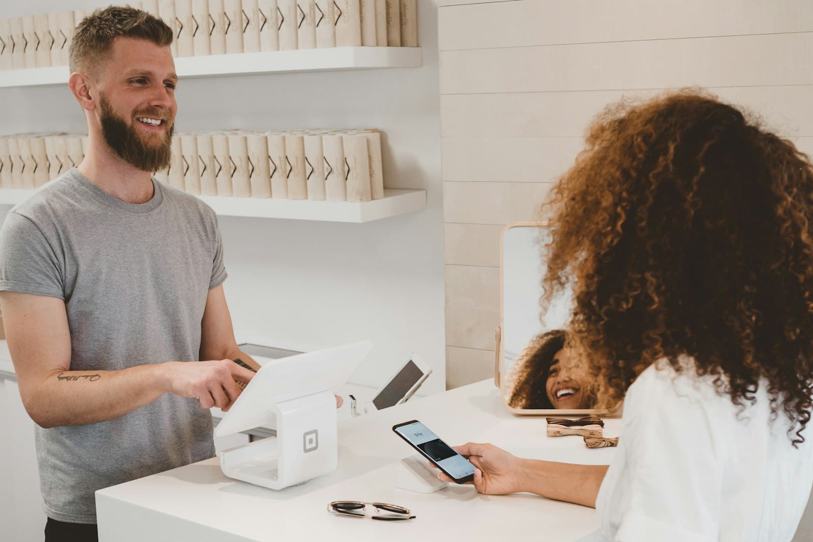 Customer paying at a modern shop counter